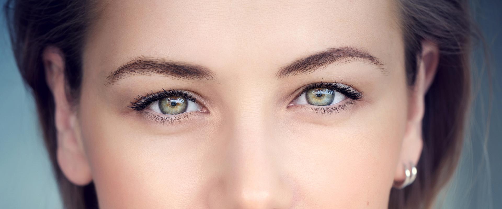 Close up of female with dark hair and green eyes