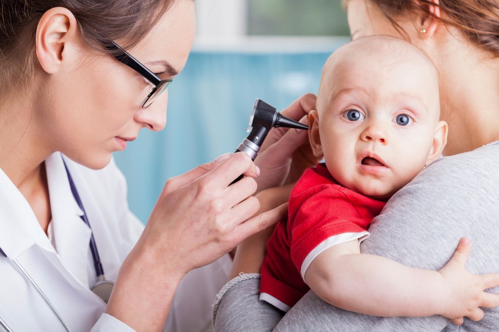 doctor looking into a babies ear