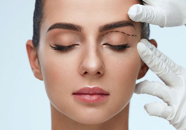 young girl getting measurements done for eyelid surgery